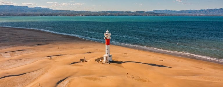 Vista aérea del Faro del Fangar en el Delta del Ebro, rodeado de dunas y paisaje costero