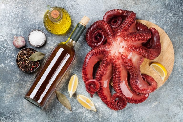 plato de pulpo a la gallega acompañado de un vino tipico de ourense, representando la autentica gastronomia gallega y comida tradicional de galicia