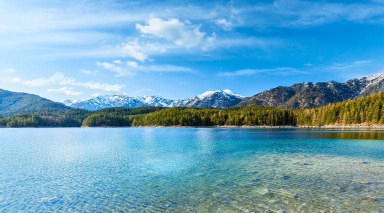 Vista panorámica del lago Eibsee en Baviera Alemania con aguas cristalinas y montañas nevadas al fondo